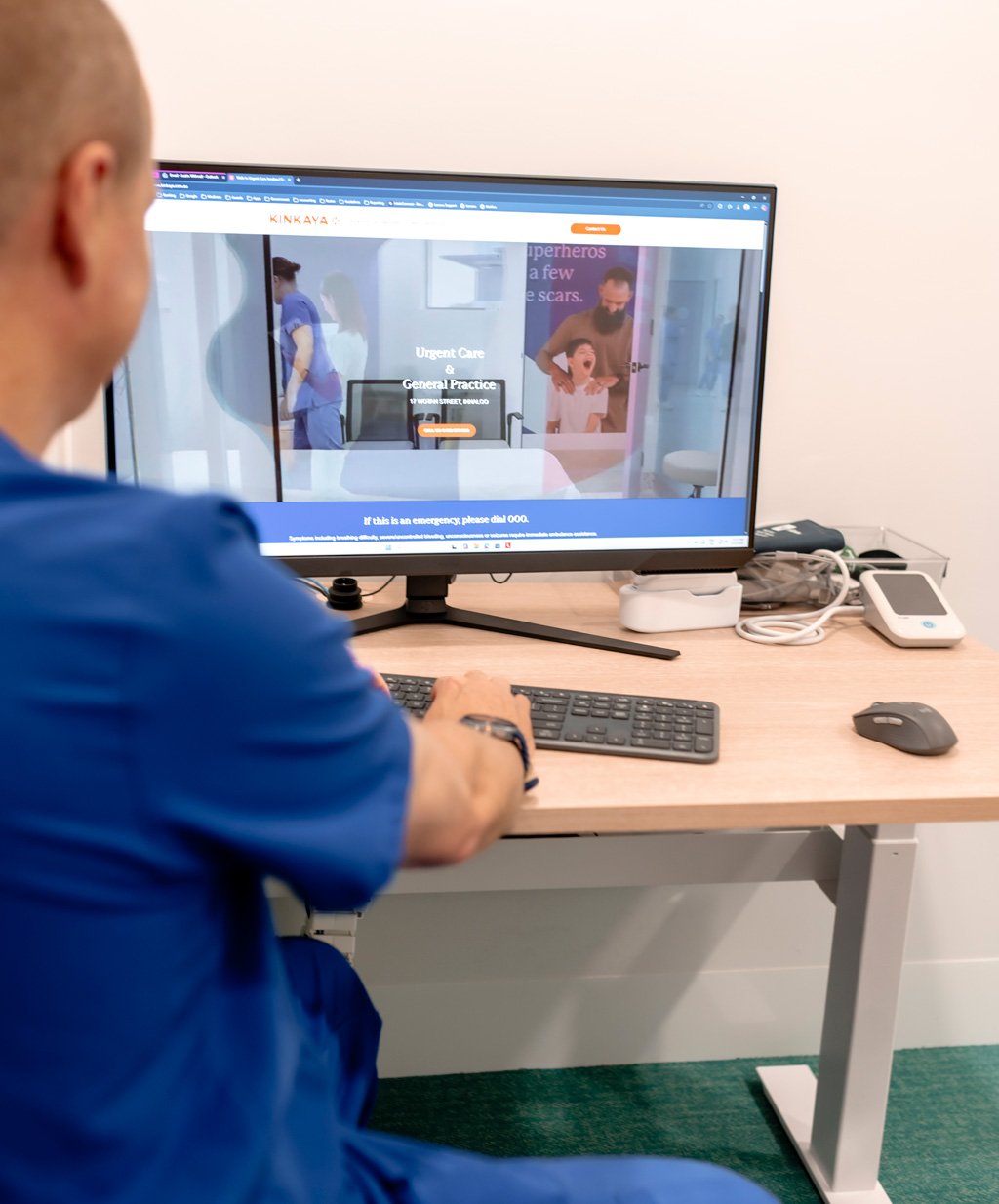 Doctor-at-Desk-Viewing-Kinkaya-Website-on-Monitor